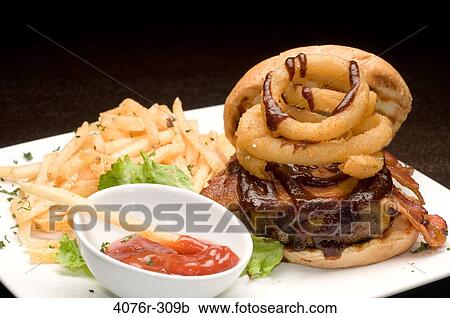 Burger and French fries with a bowl of ketchup View Large Photo Image Stock Image - Burger and French fries with a bowl of ketchup. Fotosearch