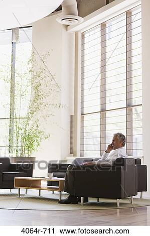 Business executive waiting in office lobby View Large Photo Image Stock Image - Business executive waiting in office lobby. Fotosearch
