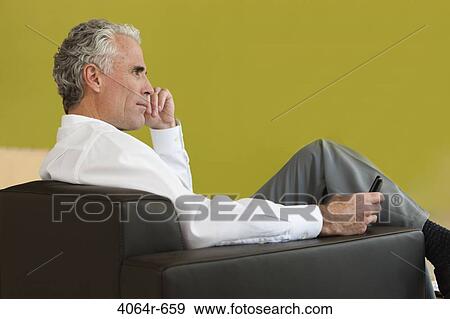 Business executive waiting in office lobby View Large Photo Image Stock Photo - Business executive waiting in office lobby. Fotosearch