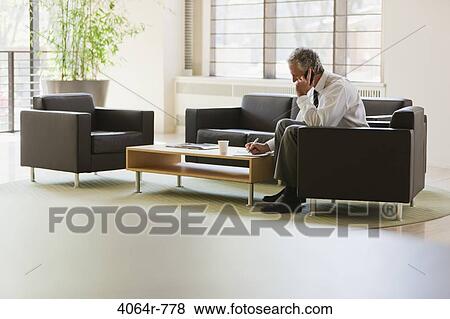 Business executive waiting in office lobby View Large Photo Image Stock Photo - Business executive waiting in office lobby. Fotosearch