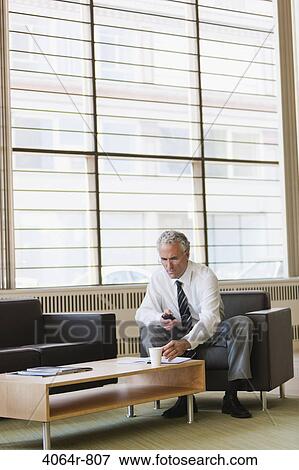 Business executive waiting in office lobby View Large Photo Image Stock Photo - Business executive waiting in office lobby. Fotosearch