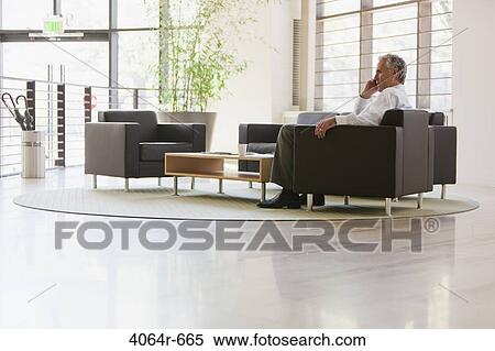 Stock Photography - Business executive waiting in office lobby. Fotosearch