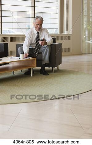 Business executive waiting in office lobby View Large Photo Image Stock Photography - Business executive waiting in office lobby. Fotosearch