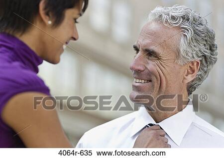Stock Photography - Businessman and woman talking outdoors. Fotosearch