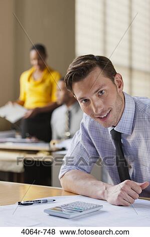 Businessman at desk in office, portrait View Large Photo Image Stock Photo - Businessman at desk in office, portrait. Fotosearch