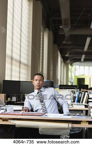 Stock Photography - Businessman at desk in office. Fotosearch