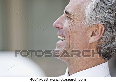 Businessman laughing outdoors View Large Photo Image Stock Image - Businessman laughing outdoors. Fotosearch