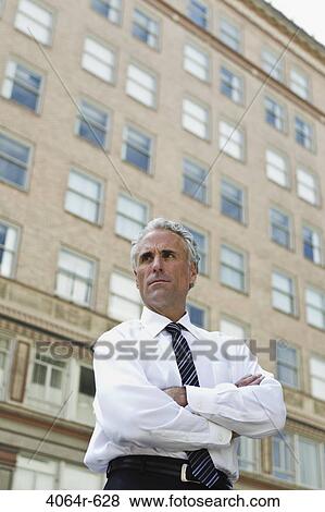 Businessman outside office in city View Large Photo Image Stock Photo - Businessman outside office in city. Fotosearch