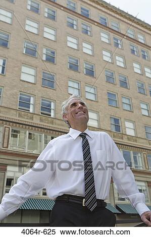 Businessman outside office in city View Large Photo Image Stock Photography - Businessman outside office in city. Fotosearch