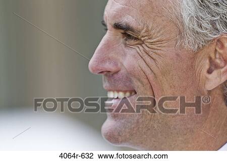 Stock Image - Businessman smiling outdoors. Fotosearch