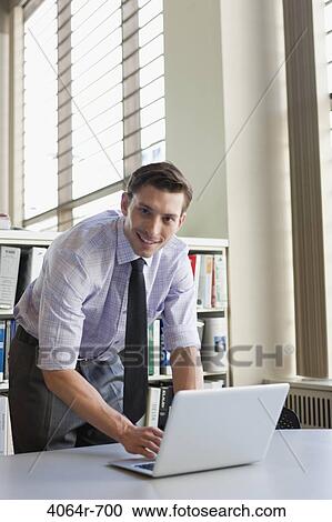 Businessman working at laptop View Large Photo Image Stock Image - Businessman working at laptop. Fotosearch