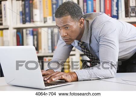 Businessman working on laptop View Large Photo Image Picture - Businessman working on laptop. Fotosearch