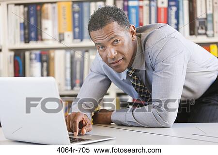 Businessman working on laptop View Large Photo Image Stock Photography - Businessman working on laptop. Fotosearch