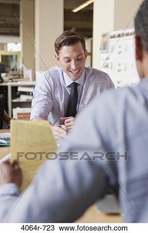 Businessman working on project at office View Large Photo Image Stock Image - Businessman working on project at office. Fotosearch
