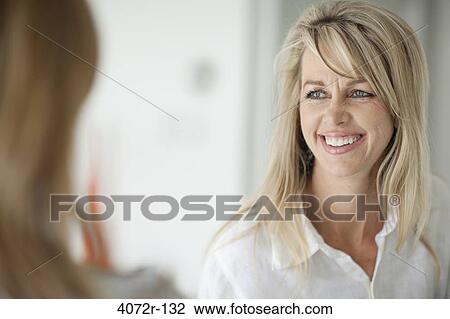 Businesswoman smiling during a discussion View Large Photo Image Stock Image - Businesswoman smiling during a discussion. Fotosearch