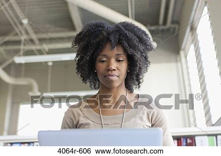 Businesswomen using laptop in office View Large Photo Image Stock Photograph - Businesswomen using laptop in office. Fotosearch