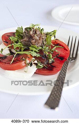 Caprese salad with Heirloom tomatoes, buffalo mozzarella balsamic reduction and basil chiffonade View Large Photo Image Stock Image - Caprese salad with Heirloom tomatoes, buffalo mozzarella balsamic reduction and basil chiffonade. Fotosearch