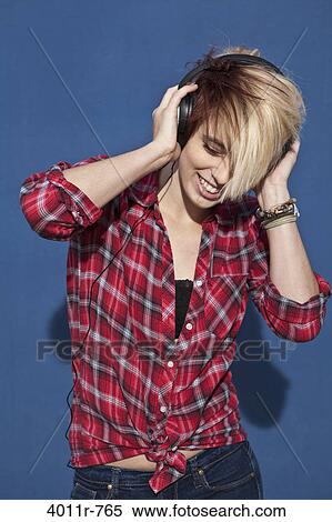 Cheerful teenage girl listening to music View Large Photo Image Stock Photography - Cheerful teenage girl listening to music. Fotosearch
