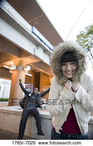 Stock Image - Cheerful young inter-racial couple outside a train station. Fotosearch