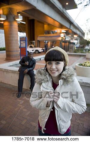 Cheerful young inter-racial couple outside a train station View Large Photo Image Stock Photo - Cheerful young inter-racial couple outside a train station. Fotosearch