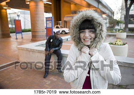 Cheerful young inter-racial couple outside a train station View Large Photo Image Stock Photo - Cheerful young inter-racial couple outside a train station. Fotosearch