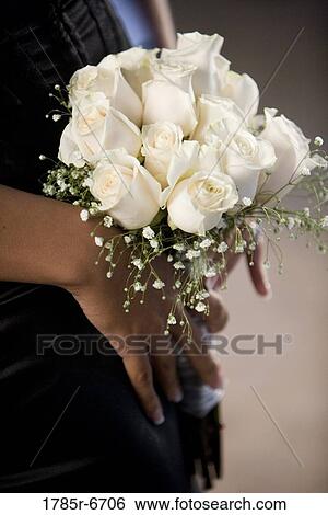 Close-up of a bouquet of white roses in the hands of a woman in black View Large Photo Image Stock Photograph - Close-up of a bouquet of white roses in the hands of a woman in black. Fotosearch