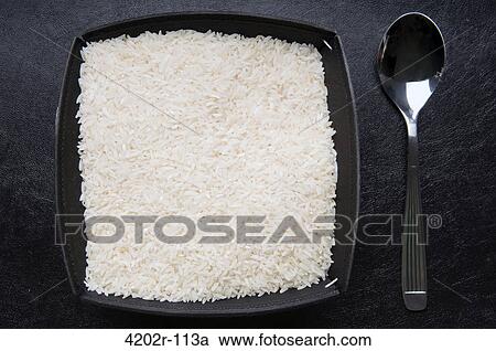 Close-up of a bowl of uncooked rice with spoon View Large Photo Image Stock Image - Close-up of a bowl of uncooked rice with spoon. Fotosearch