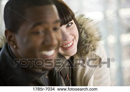Close-up of a cheerful young inter-racial couple View Large Photo Image Picture - Close-up of a cheerful young inter-racial couple. Fotosearch