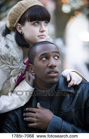 Close-up of a contemplative young inter-racial couple View Large Photo Image Stock Photo - Close-up of a contemplative young inter-racial couple. Fotosearch