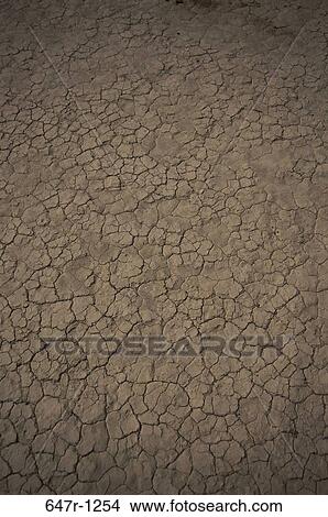 Picture - Close-up of a cracked mud floor. Fotosearch