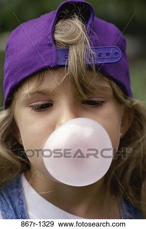 Close-up of a girl blowing a bubble with bubble gum View Large Photo Image Stock Photo - Close-up of a girl blowing a bubble with bubble gum. Fotosearch
