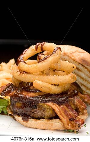 Close-up of a hamburger with onion rings View Large Photo Image Stock Image - Close-up of a hamburger with onion rings. Fotosearch