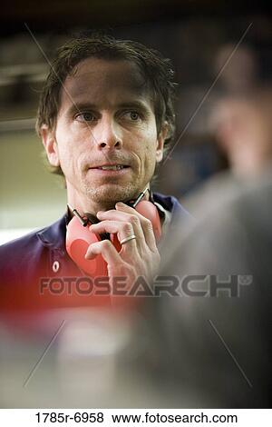 Close-up of a man holding on to his hearing protection in a factory View Large Photo Image Stock Photo - Close-up of a man holding on to his hearing protection in a factory. Fotosearch