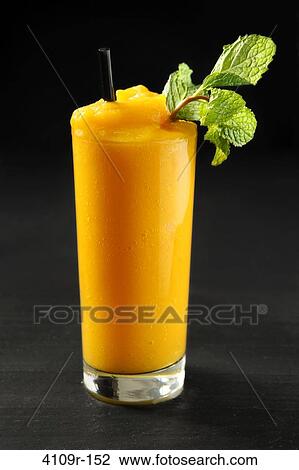 Close-up of a mango smoothie with mint sprig View Large Photo Image Stock Image - Close-up of a mango smoothie with mint sprig. Fotosearch