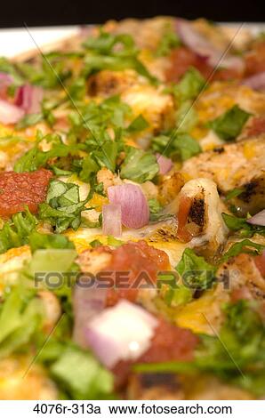 Stock Image - Close-up of a Mexican pizza with toppings of vegetables. Fotosearch