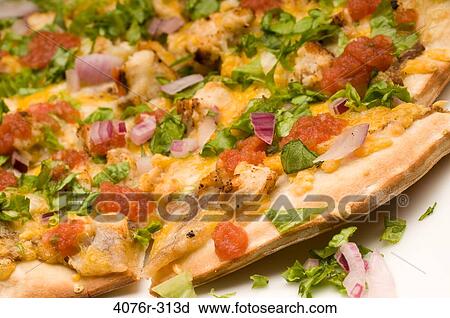 Stock Image - Close-up of a Mexican pizza with toppings of vegetables. Fotosearch