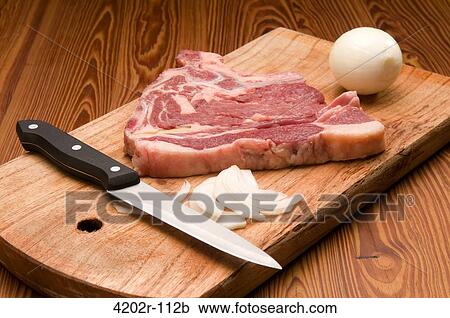 Close-up of a raw steak with a knife and onion on a cutting board View Large Photo Image Stock Image - Close-up of a raw steak with a knife and onion on a cutting board. Fotosearch