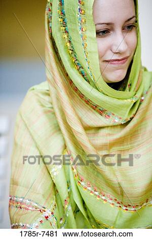 Close-up of a smiling young woman wearing a head scarf View Large Photo Image Stock Image - Close-up of a smiling young woman wearing a head scarf. Fotosearch