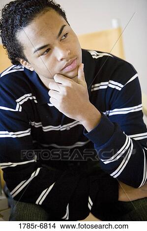 Picture - Close-up of a teenage boy in contemplation. Fotosearch