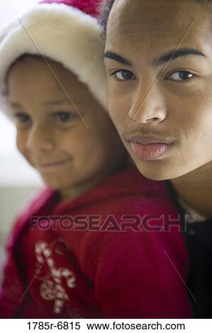 Close-up of a teenage boy with his younger sister View Large Photo Image Stock Photography - Close-up of a teenage boy with his younger sister. Fotosearch