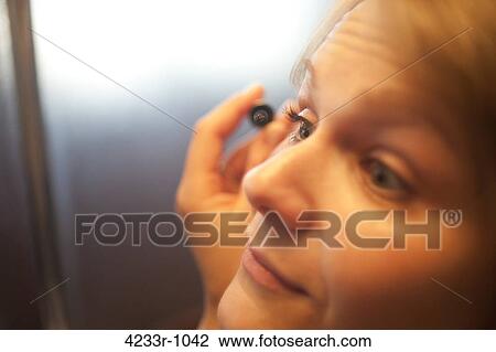 Close-up of a woman applying make-up View Large Photo Image Stock Image - Close-up of a woman applying make-up. Fotosearch