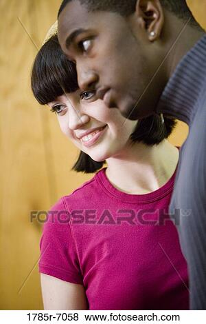 Stock Photo - Close-up of a young inter-racial couple. Fotosearch