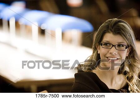 Close-up of a young woman sitting in the reading room of a library View Large Photo Image Stock Image - Close-up of a young woman sitting in the reading room of a library. Fotosearch