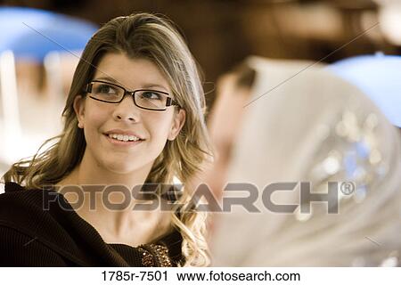 Close-up of a young woman sitting in the reading room of a library View Large Photo Image Stock Image - Close-up of a young woman sitting in the reading room of a library. Fotosearch