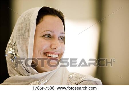Close-up of a young woman smiling wearing a headscarf View Large Photo Image Stock Photograph - Close-up of a young woman smiling wearing a headscarf. Fotosearch