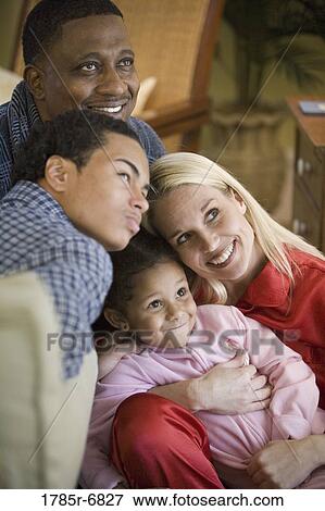 Stock Photo - Close-up of an inter-racial family dressed in pajamas. Fotosearch