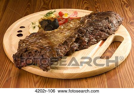 Close-up of asado on a cutting board View Large Photo Image Stock Photograph - Close-up of asado on a cutting board. Fotosearch