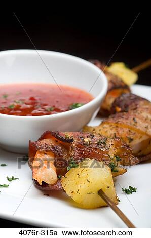 Close-up of bacon wrapped shrimp and pineapple on skewer with a bowl of sauce View Large Photo Image Stock Image - Close-up of bacon wrapped shrimp and pineapple on skewer with a bowl of sauce. Fotosearch