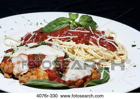 Close up of chicken meal with parmesan, noodles and basil View Large Photo Image Stock Image - Close up of chicken meal with parmesan, noodles and basil. Fotosearch