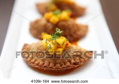 Picture - Close-up of Cuban empanadas served in a plate. Fotosearch